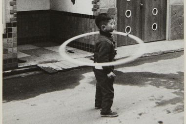 Kenji Ishiguro 石黒 健治. Boy with Hula Hoop. 1959. Gelatin silver print.